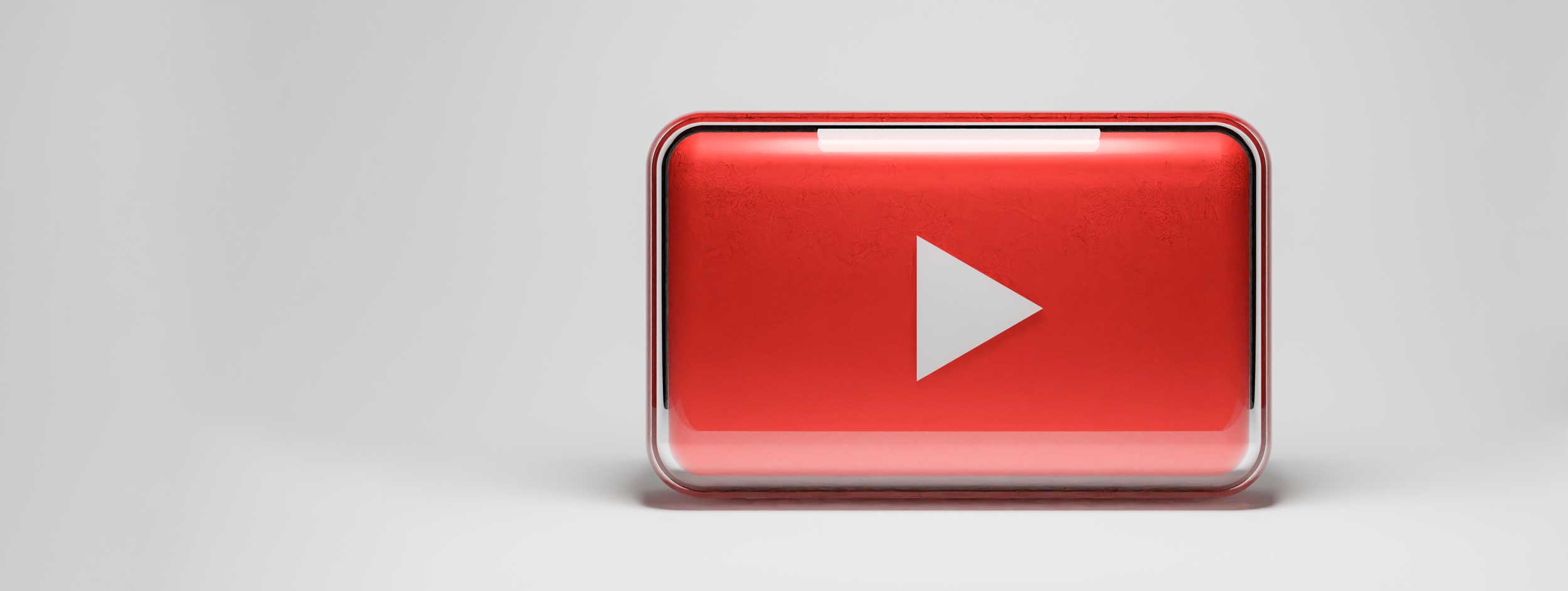 The YouTube play button logo in glass form for the media tips page