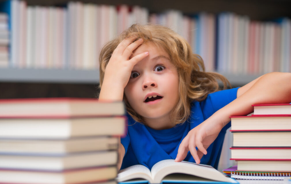 Angry child surrounded by books for press releases blog