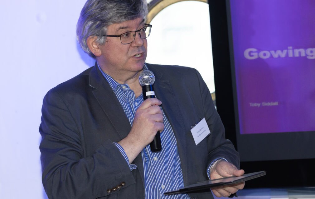 Guy Clapperton holding a mic